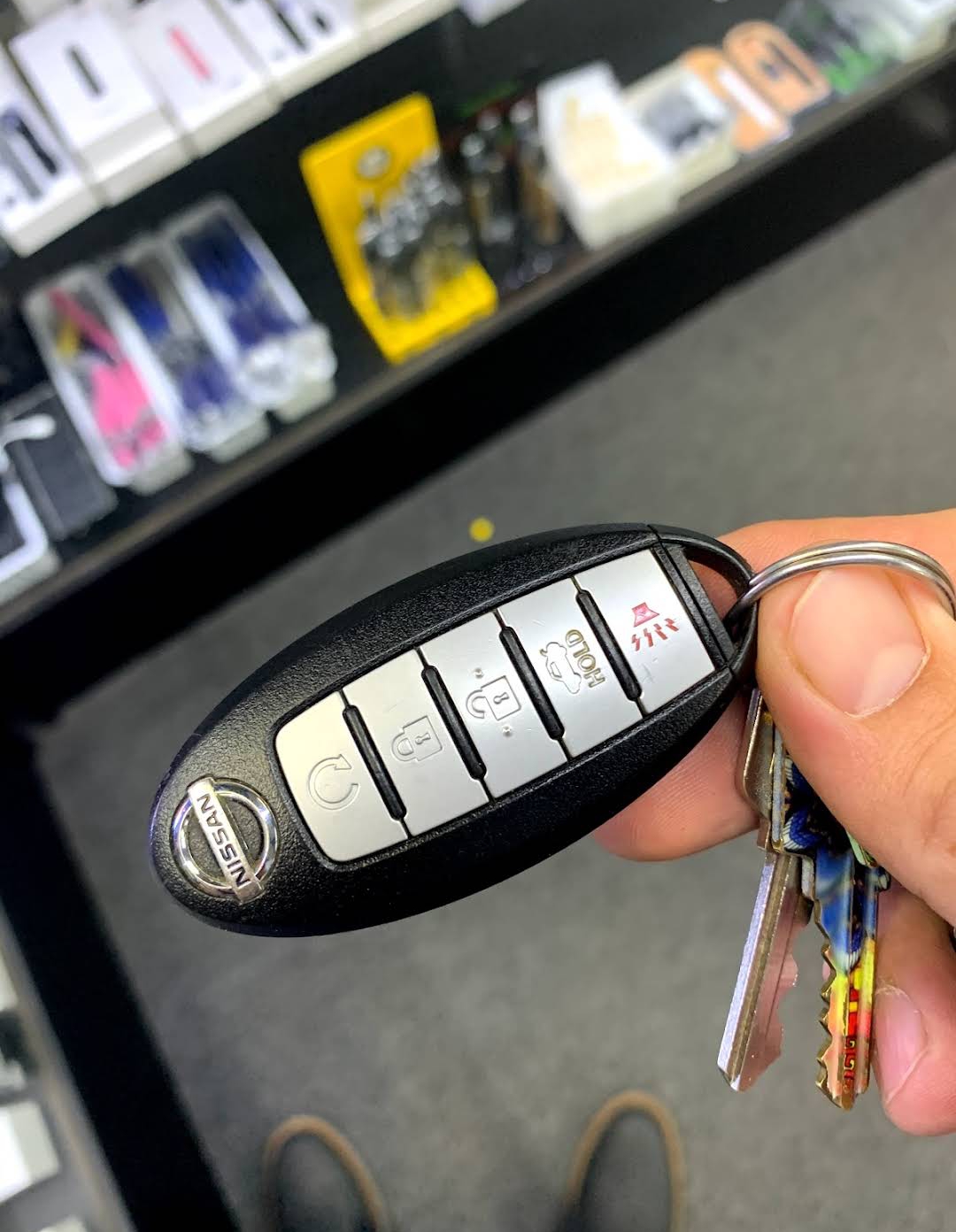 Cut and programmed 5-button Nissan smart key inside the locksmith key shop