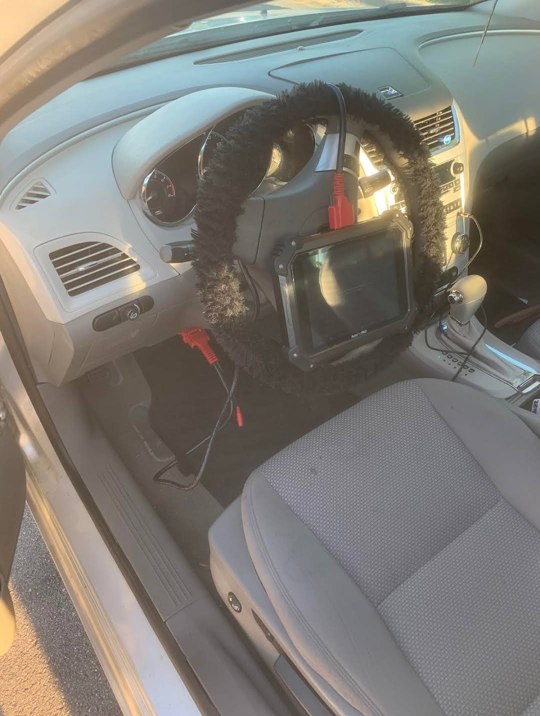AutoProPad programming tool connected inside a Chevrolet during key programming